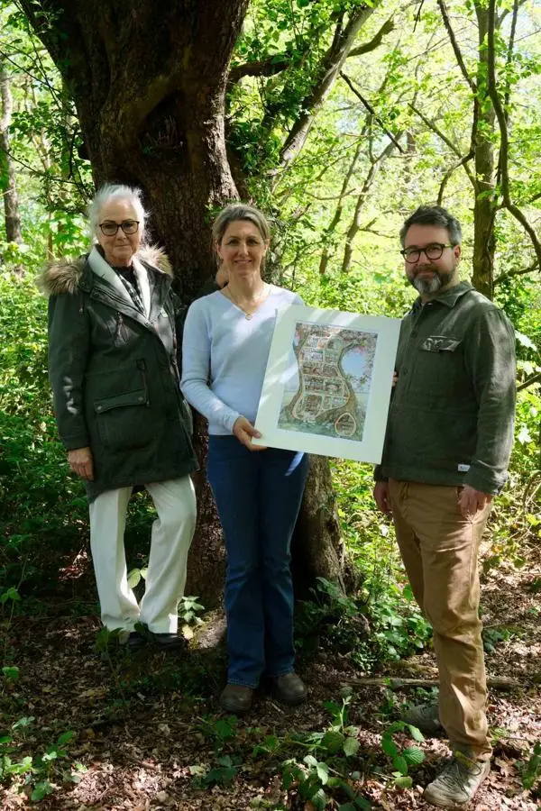 Chairman of Epping Forest Caroline Haines,  and Lizzie and Pete Barklem, stand in front of a tree in Epping Forest 