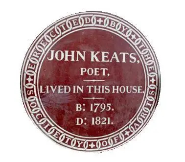 A round red plaque with the words 'John Keats, poet, lived in this house' and the years of his birth and death.